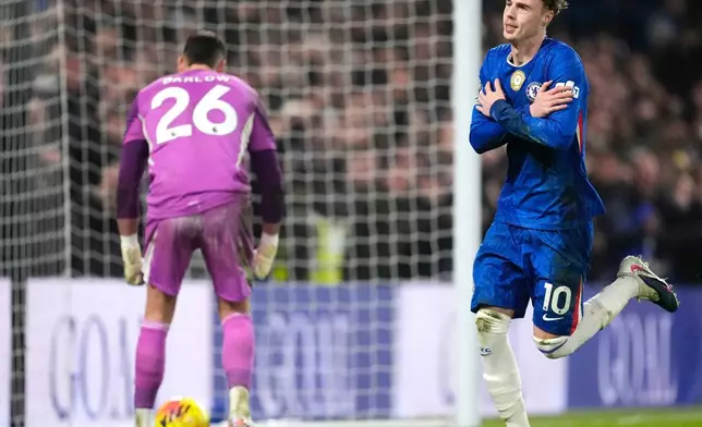 Chelsea's Cole Palmer, right, celebrates scoring his side's second goal of the game from a penalty against Leeds United's during an English Premier League soccer match in London, Tuesday, Feb. 10, 2026. (Nick Potts/PA via AP)