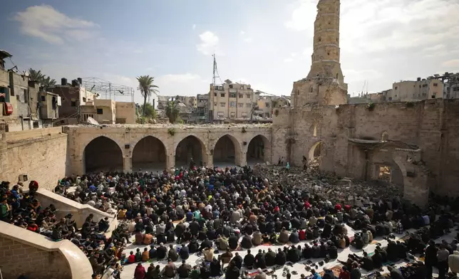 FILE - Palestinians gather to attend Friday prayers at the Great Omari Mosque, which was damaged during the Israeli military's air and ground operation in Gaza City, Friday, Feb. 14, 2025. (AP Photo/Jehad Alshrafi, File)