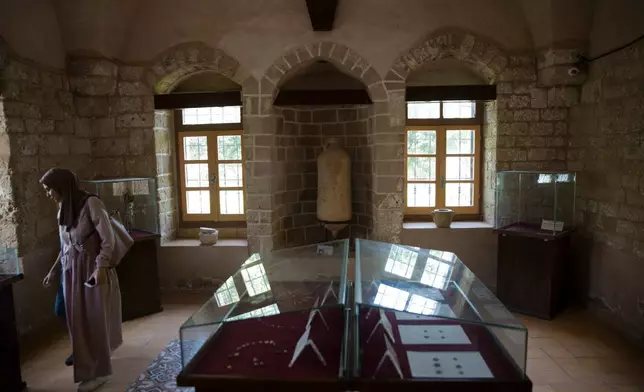 A visitor looks at antiquities displayed at the Pasha Palace, a museum in Gaza City that was later damaged in the Israel-Hamas war, in Gaza City, July 16, 2019. (AP Photo/Khalil Hamra, File)