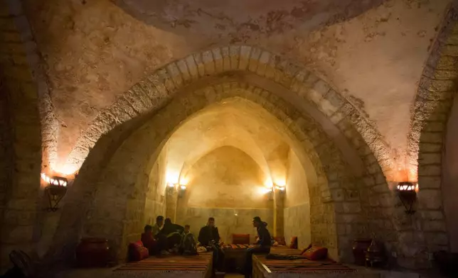 FILE - Palestinians rest at the reception of Hamam al-Sumara a historic bathhouse in Gaza City, Saturday, May 2, 2015. Hamam al-Sumara means "Samaritans' Bath" in Arabic. (AP Photo/Khalil Hamra, File)