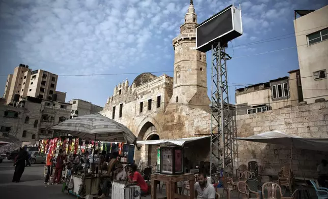 FILE - Palestinian vendors set up outside the Barqouq Castle, which was later damaged during the Israel-Hamas war, in Khan Younis, southern Gaza Strip, Wednesday, July 17, 2019. (AP Photo/Khalil Hamra, File)