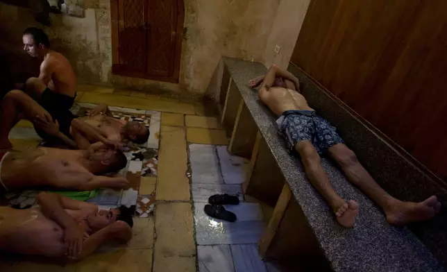FILE - Palestinians rest outside the steam room at Hamam al-Sumara, a historic bathhouse in Gaza City, Saturday, May 2, 2015. Hamam al-Sumara means "Samaritans' Bath" in Arabic. (AP Photo/Khalil Hamra, File)