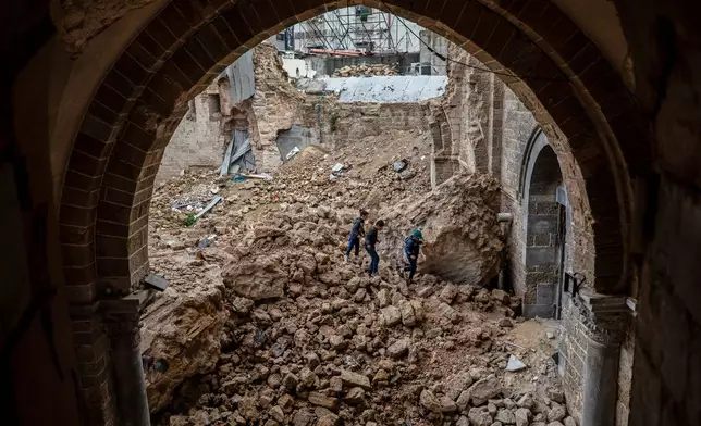Palestinian children walk through rubble at the Great Omari Mosque in Gaza City after it was damaged by an Israeli strike during the war with Hamas, Wednesday. Feb. 12, 2025. (AP Photo/Jehad Alshrafi)