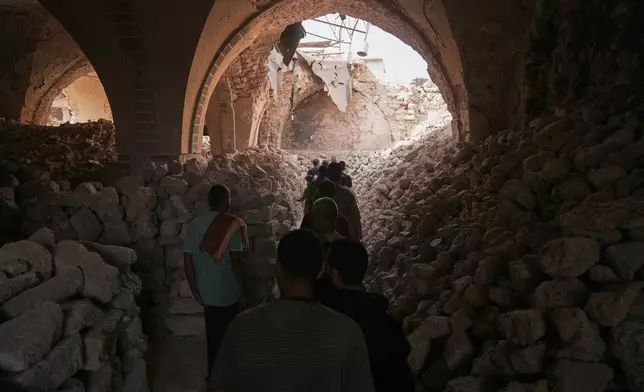 FILE - Palestinians attend Friday prayers at the Great Omari Mosque in Gaza City after it was damaged by Israeli bombardment during the Israel–Hamas war, Friday, Nov. 7, 2025. (AP Photo/Jehad Alshrafi, File)