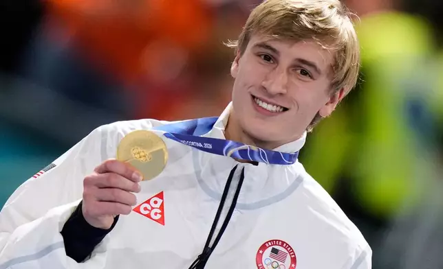 Jordan Stolz of the U.S. celebrates with his gold medal on the podium of the men's 1,000 meters speedskating race at the 2026 Winter Olympics, in Milan, Italy, Wednesday, Feb. 11, 2026. (AP Photo/Luca Bruno)