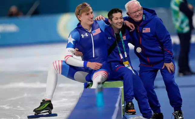 Jordan Stolz of the U.S. and coach Bob Corby, right, pose for a picture after the men's 1,000 meters speedskating race at the 2026 Winter Olympics, in Milan, Italy, Wednesday, Feb. 11, 2026. (AP Photo/Luca Bruno)