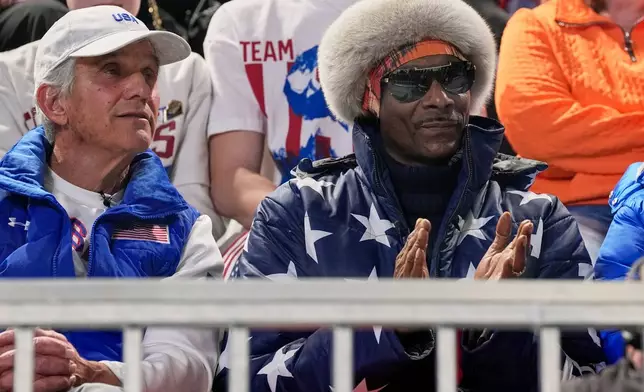 Snoop dog and five-time olympic gold medallist former speed skater Eric Heiden of the U.S. watch the men's 1,000 meters speedskating race at the 2026 Winter Olympics, in Milan, Italy, Wednesday, Feb. 11, 2026. (AP Photo/Ben Curtis)