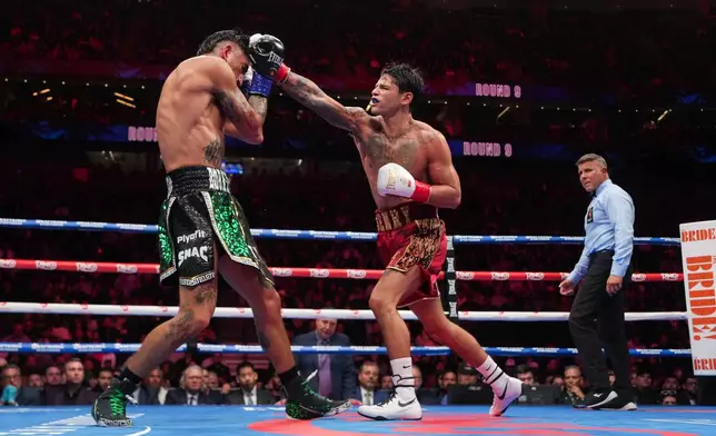 Ryan Garcia, right, fights Mario Barrios in a WBC welterweight title boxing match Saturday, Feb. 21, 2026, in Las Vegas. (AP Photo/Lucas Peltier)