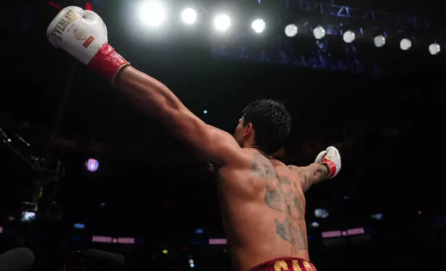 Ryan Garcia celebrates after winning in a WBC welterweight title boxing match against Mario Barrios Saturday, Feb. 21, 2026, in Las Vegas. (AP Photo/Lucas Peltier)