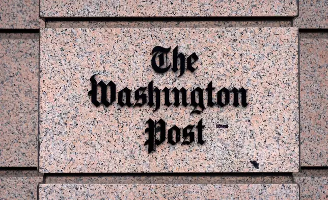 A sign for the Washington Post is seen at the company's offices, Monday, Jan. 26, 2026, in Washington. (AP Photo/Mark Schiefelbein)