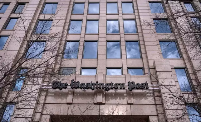 A sign for the Washington Post is seen at the company's offices, Monday, Jan. 26, 2026, in Washington. (AP Photo/Mark Schiefelbein)