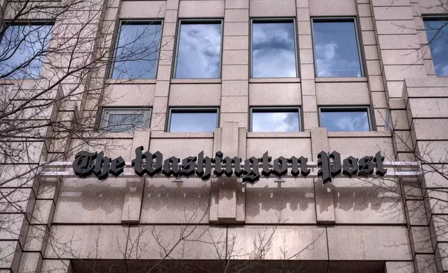 A sign for the Washington Post is seen at the company's offices, Monday, Jan. 26, 2026, in Washington. (AP Photo/Mark Schiefelbein)
