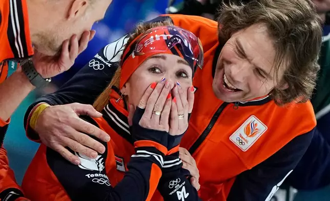 Antoinette Rijpma-de Jong of the Netherlands celebrates winning the gold medal with her coach Gerard van Velde, right, after the women's 1500 meters speedskating race at the 2026 Winter Olympics, in Milan, Italy, Friday, Feb. 20, 2026. (AP Photo/Ben Curtis)