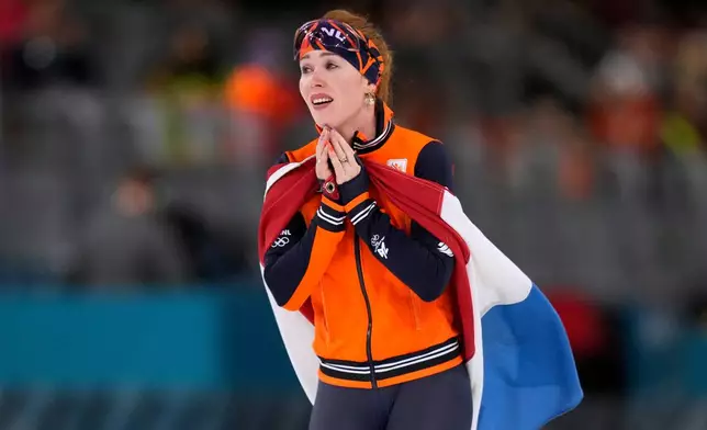 Antoinette Rijpma-de Jong of the Netherlands celebrates winning the gold medal in the women's 1500 meters speedskating race at the 2026 Winter Olympics, in Milan, Italy, Friday, Feb. 20, 2026. (AP Photo/Luca Bruno)
