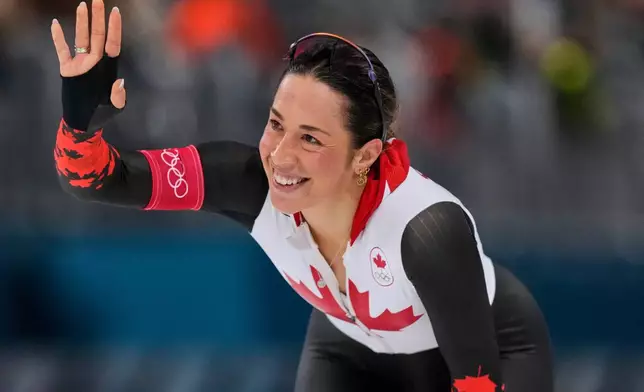 Valerie Maltais of Canada greets fans after competing in the women's 1500 meters speedskating race at the 2026 Winter Olympics, in Milan, Italy, Friday, Feb. 20, 2026. (AP Photo/Luca Bruno)