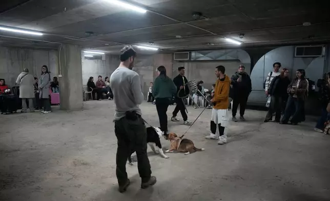 People in a shelter following alarms for incoming missile from Iran after The United States and Israel launched an attack on Iran, in Tel Aviv, Israel, Saturday, Feb. 28, 2026. (AP Photo/Ohad Zwigenberg)