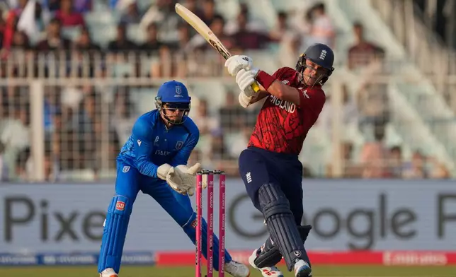 England's Sam Curran hits a six during the T20 World Cup cricket match between England and Italy in Kolkata, India, Monday, Feb. 16, 2026. (AP Photo/Bikas Das)
