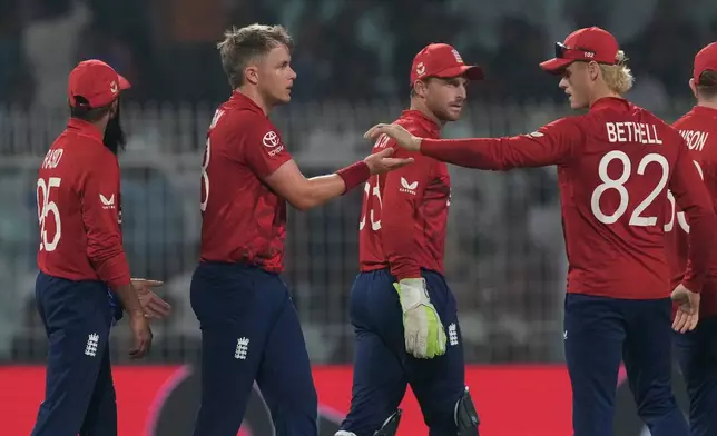 England's Sam Curran, second from left, celebrates with teammates the wicket of Italy's Grant Stewart during the T20 World Cup cricket match between England and Italy in Kolkata, India, Monday, Feb. 16, 2026. (AP Photo/Bikas Das)
