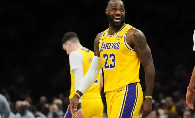 Los Angeles Lakers' LeBron James smiles after scoing during the first half of an NBA basketball game against the Brooklyn Nets Tuesday, Feb. 3, 2026, in New York. (AP Photo/Frank Franklin II)