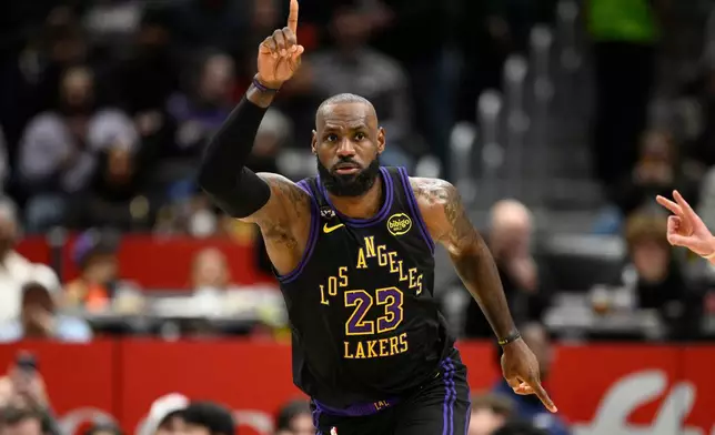Los Angeles Lakers forward LeBron James gestures after he scored during the first half of an NBA basketball game against the Washington Wizards, Friday, Jan. 30, 2026, in Washington. (AP Photo/Nick Wass)