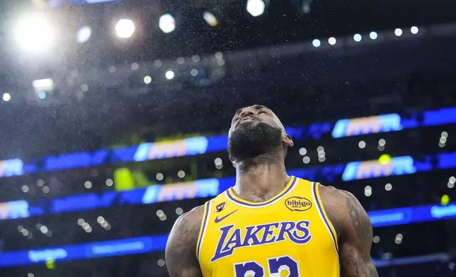 Los Angeles Lakers forward LeBron James (23) pauses after tossing power before an NBA basketball game against the Golden State Warriors Saturday, Feb. 7, 2026, in Los Angeles. (AP Photo/Jae C. Hong)