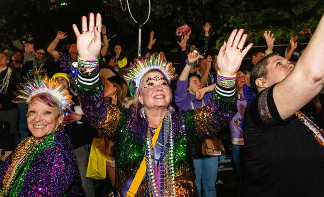 Attendees participate in the annual Krewe of Muses parade during the Mardi Gras season on Thursday, Feb. 12, 2026, in New Orleans. (Photo by Amy Harris/Invision/AP)
