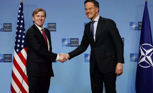 NATO Secretary General Mark Rutte, right, shakes hands with United States Undersecretary of Defense for Policy Elbridge Colby prior to a meeting of NATO defense ministers at NATO headquarters in Brussels, Thursday, Feb. 12, 2026. (AP Photo/Geert Vanden Wijngaert)
