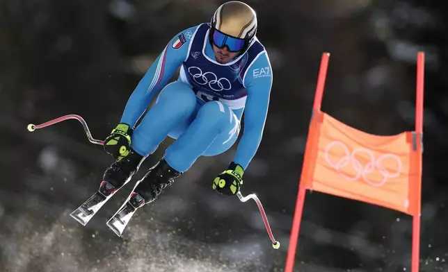 Italy's Dominik Paris speeds down the course during an alpine ski, men's downhill official training, at the 2026 Winter Olympics, in Bormio, Italy, Thursday, Feb. 5, 2026. (AP Photo/Gabriele Facciotti)