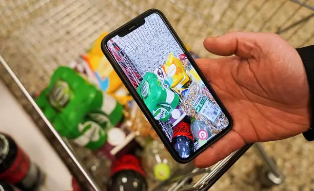 The mobile app "Made O'Meter", developed to help shoppers to identify and boycott American goods, is shown on a smartphone in a grocery store in Copenhagen, Wednesday, Jan. 28, 2026. (AP Photo/James Brooks)
