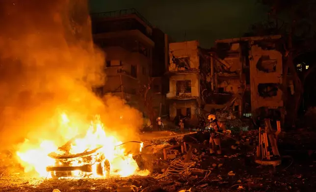FILE - Firefighters work to extinguish a blaze after a missile launched from Iran struck Tel Aviv, Israel, Monday, June 16, 2025. (AP Photo/Baz Ratner, File)