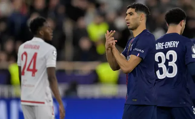 PSG's Achraf Hakimi, center, celebrates after scoring his side's second goal during the first-leg of the Champions League playoff soccer match between Monaco and Paris Saint-Germain in Monaco, Tuesday, Feb. 17, 2026. (AP Photo/Philippe Magoni)