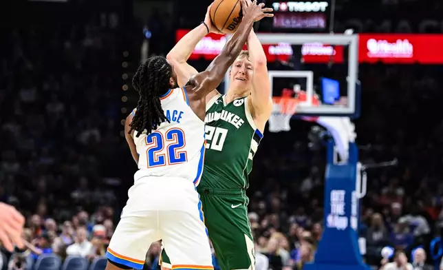Milwaukee Bucks guard AJ Green (20) looks to pass against Oklahoma City Thunder guard Cason Wallace (22) during the first half of an NBA basketball game, Thursday, Feb. 12, 2026, in Oklahoma City. (AP Photo/Gerald Leong)