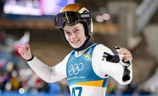 Anna Odine Stroem, of Norway, reacts after winning the gold medal in the ski jumping women's large hill individual at the 2026 Winter Olympics, in Predazzo, Italy, Sunday, Feb. 15, 2026. (AP Photo/Matthias Schrader)