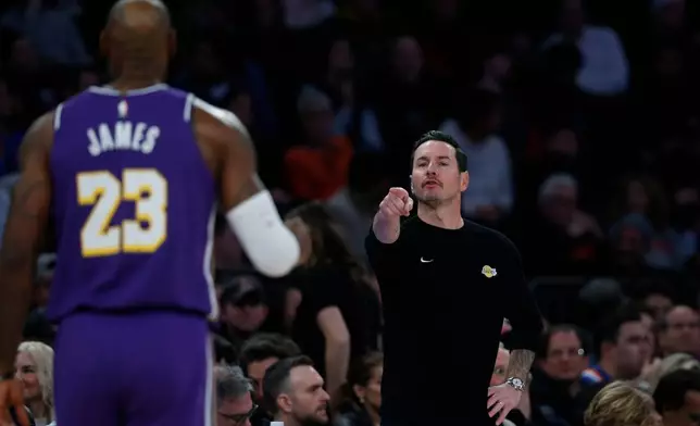 Los Angeles Lakers head coach JJ Redick, right, talks to forward LeBron James during the first half of an NBA basketball game against the New York Knicks Sunday, Feb. 1, 2026, in New York. (AP Photo/John Munson)