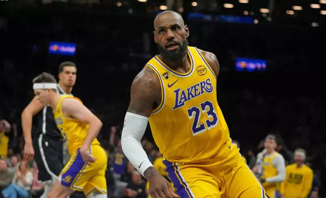 Los Angeles Lakers' LeBron James (23) reacts after dunking the ball during the first half of an NBA basketball game against the Brooklyn Nets Tuesday, Feb. 3, 2026, in New York. (AP Photo/Frank Franklin II)