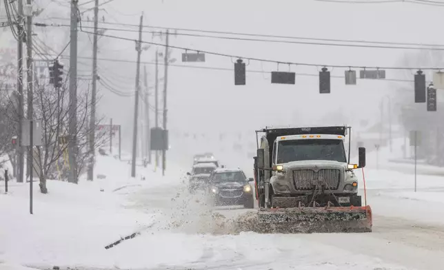 A truck plows snow along the parkway during a winter storm Saturday, Jan. 31, 2026, in Sevierville, Tenn. (AP Photo/Wade Payne)