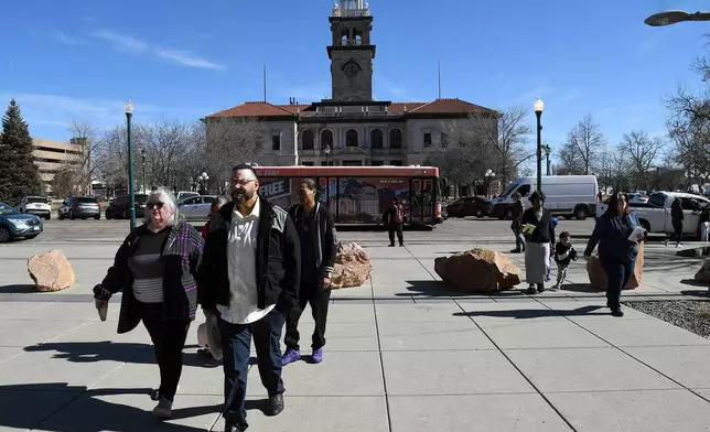 Derrick Johnson, whose mother's body was one of 189 left to decay in the Return to Nature Funeral Home in Penrose, Colo., walks toward the El Paso County Courthouse for owner Jon Hallford's sentencing in Colorado Springs, Colo., Friday, Feb. 6, 2026. (AP Photo/Thomas Peipert)