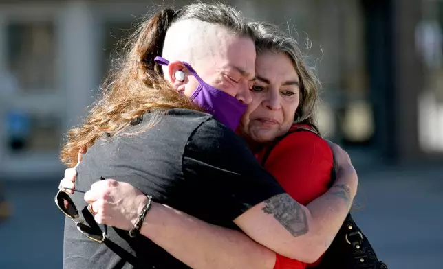 Crystina Page, left, hugs Angelika Stedman outside of the El Paso County Courthouse in Colorado Springs, Colo., Friday, Feb. 6, 2026, ahead of the sentencing of Return to Nature funeral home owner Jon Hallford. (AP Photo/Thomas Peipert)