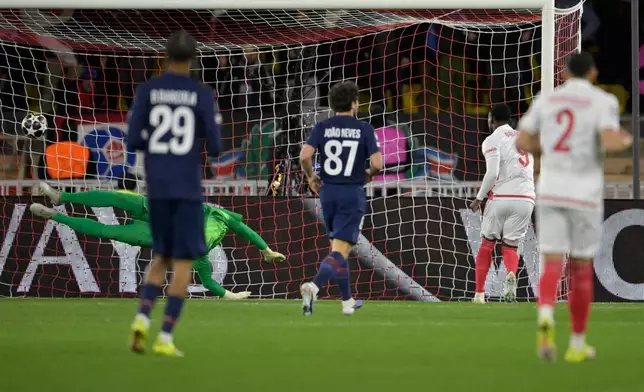 Monaco's Folarin Balogun, second right, scores the opening goal during the first-leg of the Champions League playoff soccer match between Monaco and Paris Saint-Germain in Monaco, Tuesday, Feb. 17, 2026. (AP Photo/Philippe Magoni)