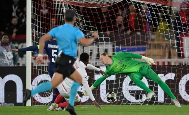 Monaco's Folarin Balogun scores his side's second goal during the first-leg of the Champions League playoff soccer match between Monaco and Paris Saint-Germain in Monaco, Tuesday, Feb. 17, 2026. (AP Photo/Philippe Magoni)