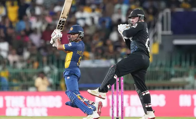 Sri Lanka's Dunith Wellalage plays a shot during the T20 World Cup cricket match between Sri Lanka and New Zealand in Colombo, Sri Lanka, Wednesday, Feb. 25, 2026. (AP Photo/Eranga Jayawardena)