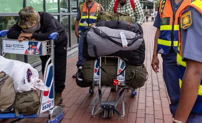 South African men who were allegedly tricked into fighting for Russia in the war in Ukraine arrive at King Shaka International Airport in Durban, South Africa, Wednesday, Feb. 25, 2026. (AP Photo/Str)