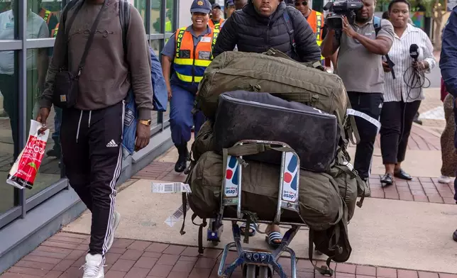South African men who were allegedly tricked into fighting for Russia in the war in Ukraine arrive at King Shaka International Airport in Durban, South Africa, Wednesday, Feb. 25, 2026. (AP Photo/Str)