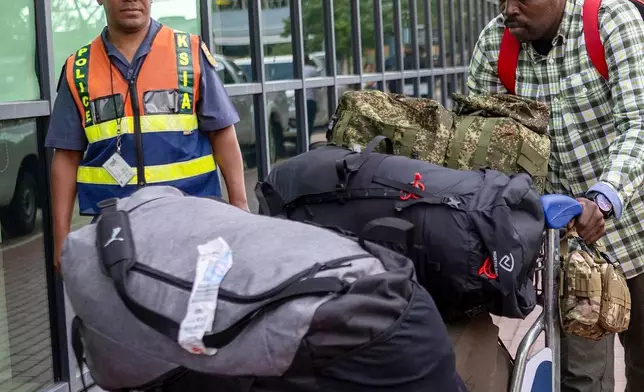 South African men who were allegedly tricked into fighting for Russia in the war in Ukraine arrive at King Shaka International Airport in Durban, South Africa, Wednesday, Feb. 25, 2026. (AP Photo/Str)