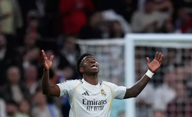 Real Madrid's Vinicius Junior celebrates after scoring his side's second goal during the second leg of the Champions League playoff soccer match between Real Madrid and Benfica in Madrid, Spain, Wednesday, Feb. 25, 2026. (AP Photo/Manu Fernandez)