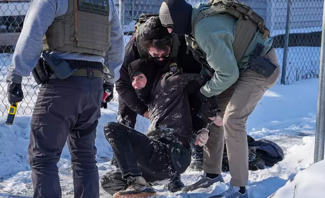 An person is detained by federal agents on Tuesday, Feb. 3, 2026, in Minneapolis. (AP Photo/Ryan Murphy)