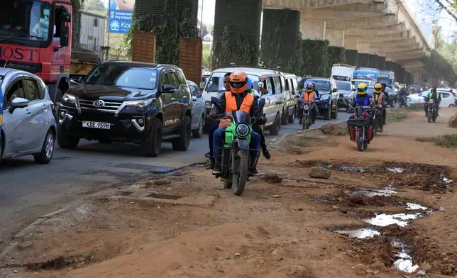 A man rides an electric motorcycle in Nairobi, Kenya, Thursday, Jan. 29, 2026. (AP Photo/Andrew Kasuku)