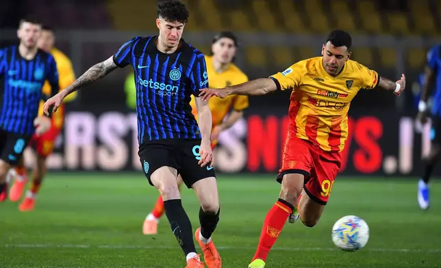 Lecce's Walid Cheddira, right, and Inter's Alessandro Bastoni in action during the Italian Serie A soccer match between Lecce and Inter Milan in Lecce, Italy, Saturday, Feb. 21, 2026. (Giovanni Evangelista/LaPresse via AP)