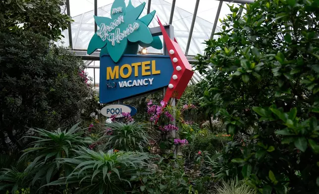 A motel sign is displayed as finishing touches are placed on the 12th annual Chicago Botanic Garden Orchid Show, Friday, Feb. 6, 2026, in Glencoe, Ill. (AP Photo/Erin Hooley)
