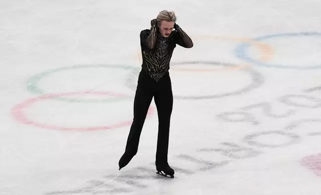 Ilia Malinin of the United States does a back flip while competing during the men's free skate program in figure skating at the 2026 Winter Olympics, in Milan, Italy, Friday, Feb. 13, 2026. (AP Photo/Stephanie Scarbrough)